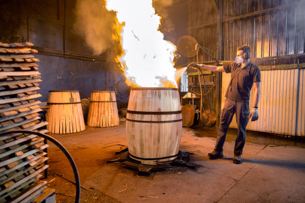 Cooperage worker firing the inside of a new whiskey barrel