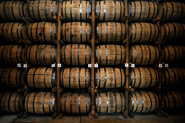 Stacked bourbon barrels inside a rickhouse