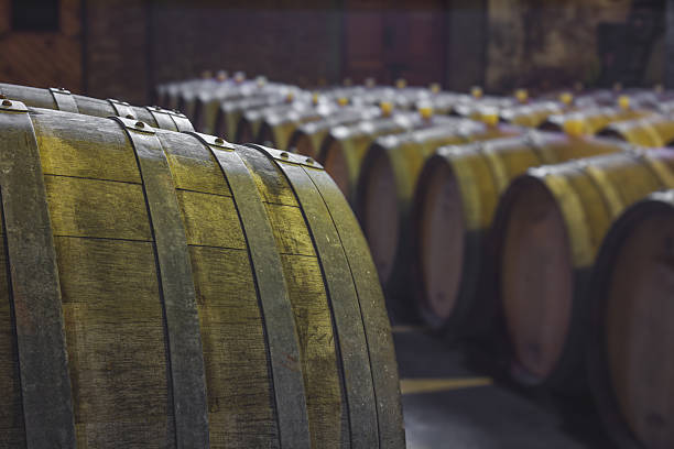Rows of whiskey barrels maturing in a warehouse