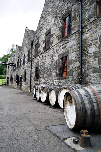 Irish whiskey casks beside a traditional warehouse
