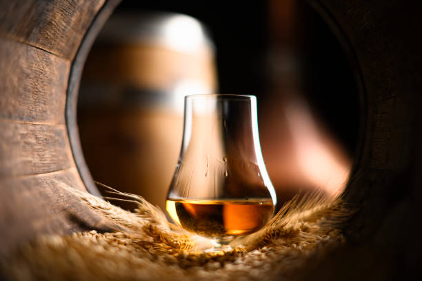 Irish whiskey glass framed by a cask