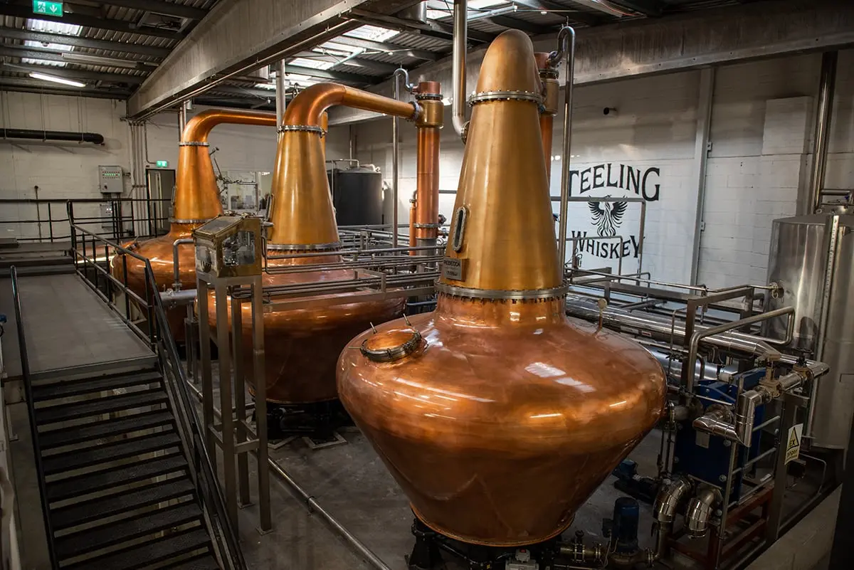Three copper pot stills at Teeling Whiskey Distillery in Dublin