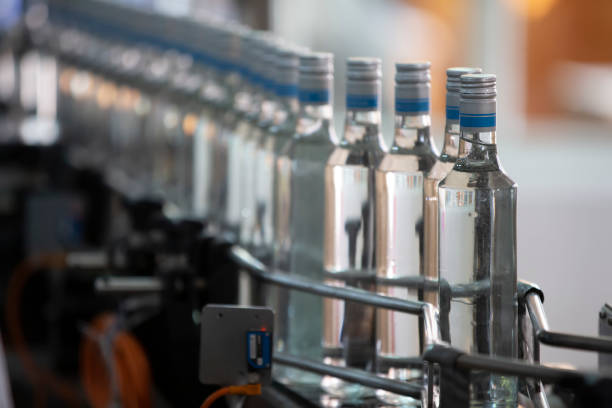 Vodka bottles moving through a commercial bottling line