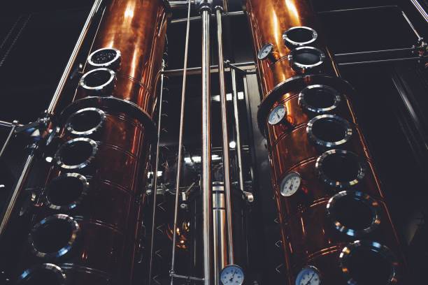 Tall copper rectification columns inside a distillery